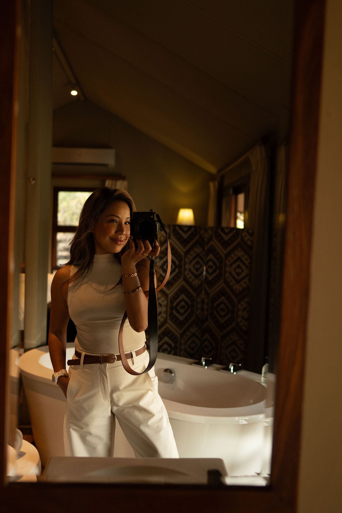 Ashley photographing in a mirror, camera in hand