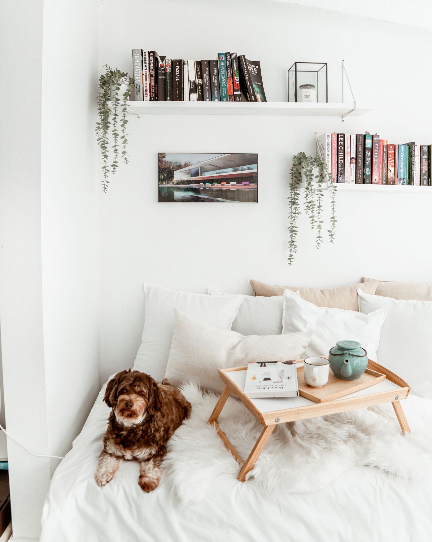 Styled bedroom with art and shelving